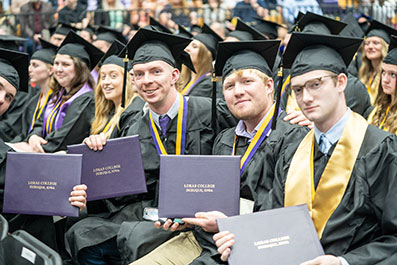 Photo of students at graduation. Link to Life Stage Gift Planner Under Age 60 Situations.