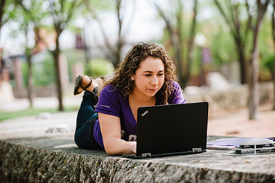 Photo of a student working on a laptop. Link to Life Stage Gift Planner Under Age 60 Situations.