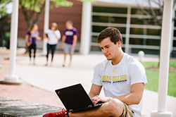 Photo of a student working on his laptop while sitting outside. Link to Closely Held Business Stock. Photo of a student working on his laptop while sitting outside. Link to Closely Held Business Stock.